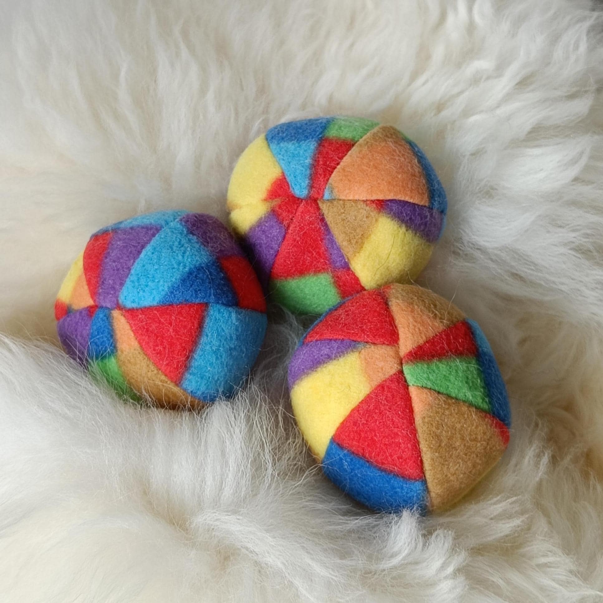 Soft fleece dog ball, pet toy with sheepskin stuffing, squeaker option available. Wool ball