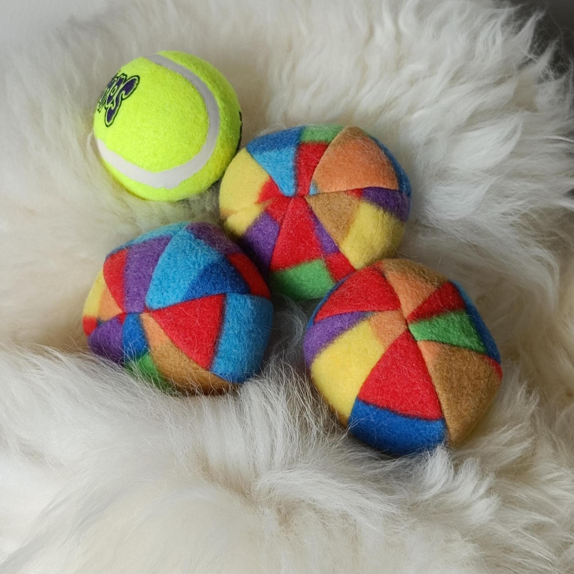 Soft fleece dog ball, pet toy with sheepskin stuffing, squeaker option available. Wool ball