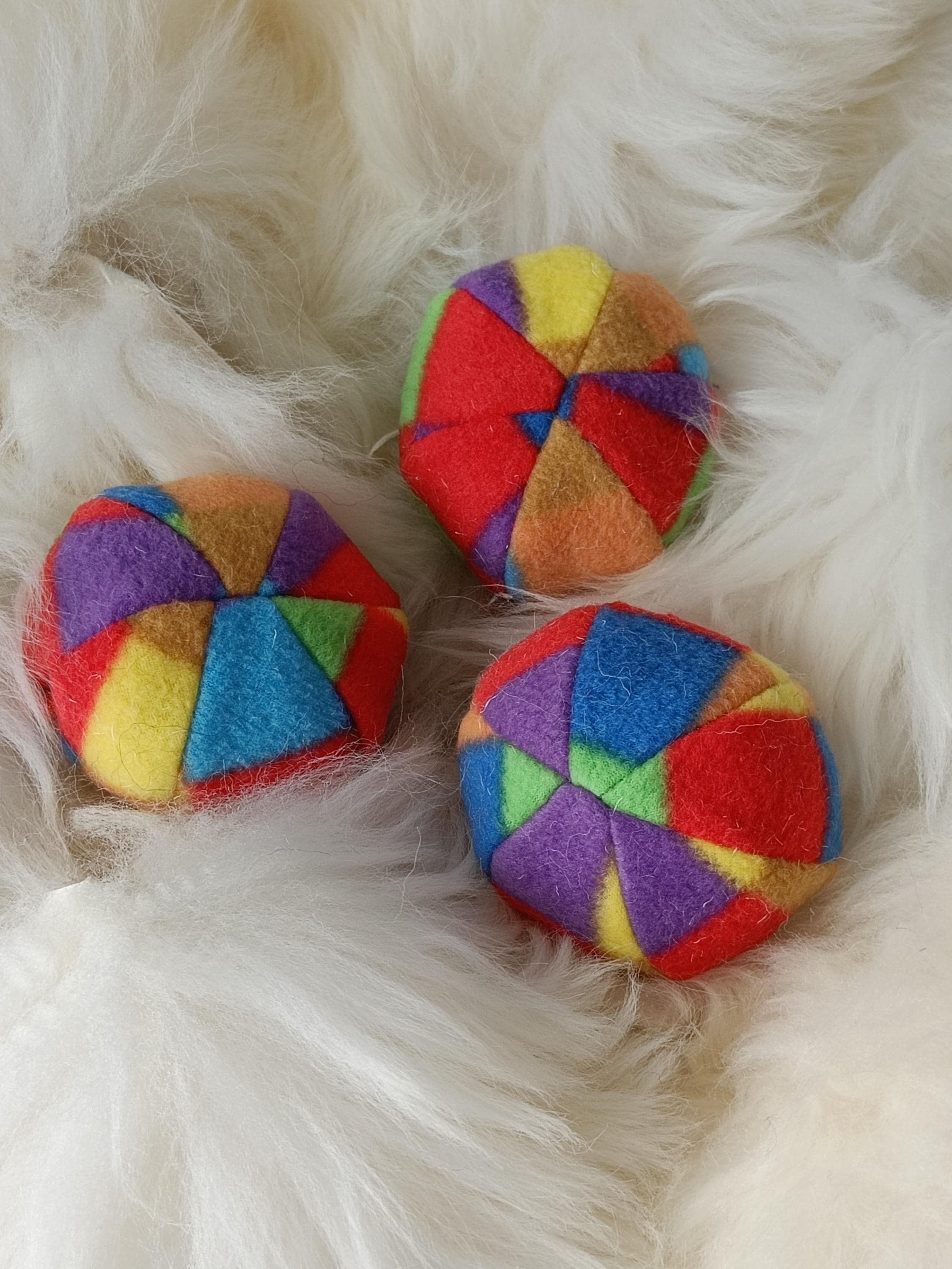 Soft fleece dog ball, pet toy with sheepskin stuffing, squeaker option available. Wool ball