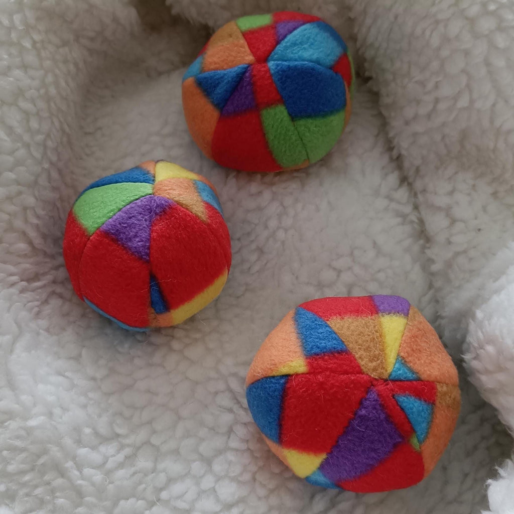 Soft fleece dog ball, pet toy with sheepskin stuffing, squeaker option available. Wool ball