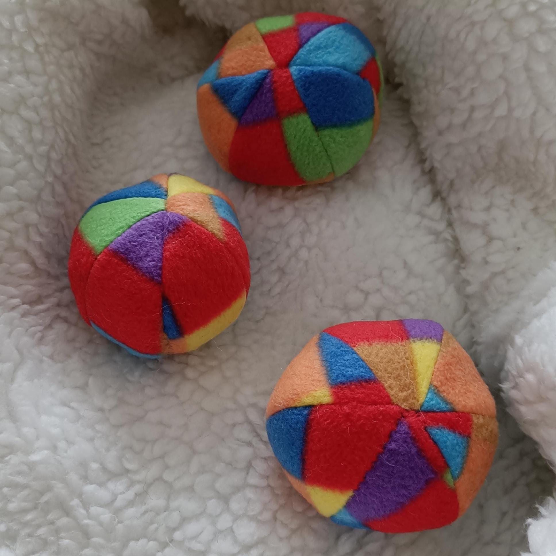 Soft fleece dog ball, pet toy with sheepskin stuffing, squeaker option available. Wool ball