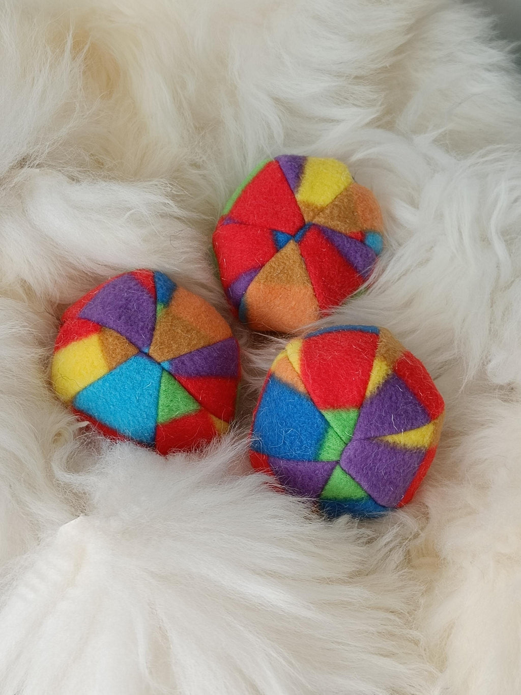 Soft fleece dog ball, pet toy with sheepskin stuffing, squeaker option available. Wool ball