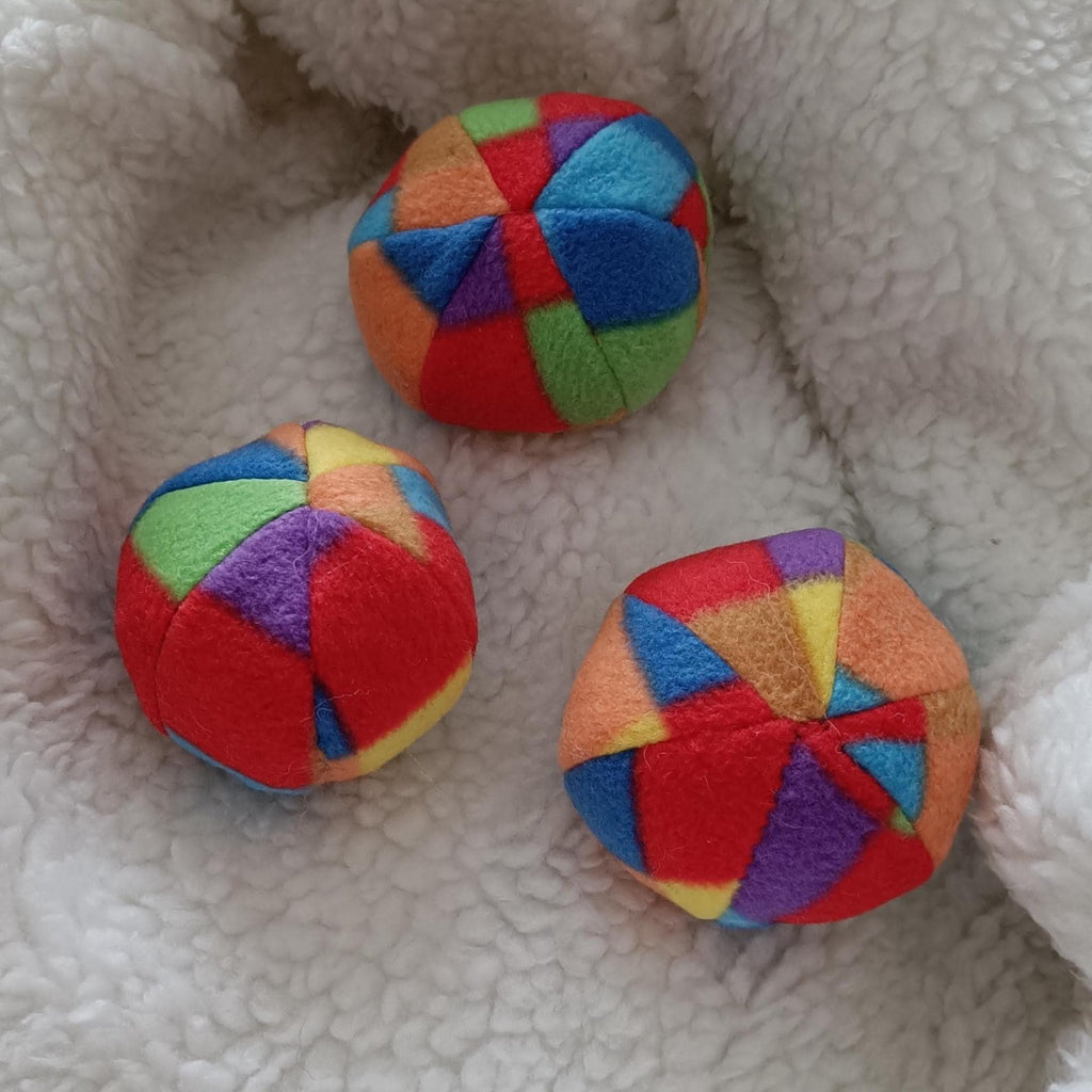Soft fleece dog ball, pet toy with sheepskin stuffing, squeaker option available. Wool ball